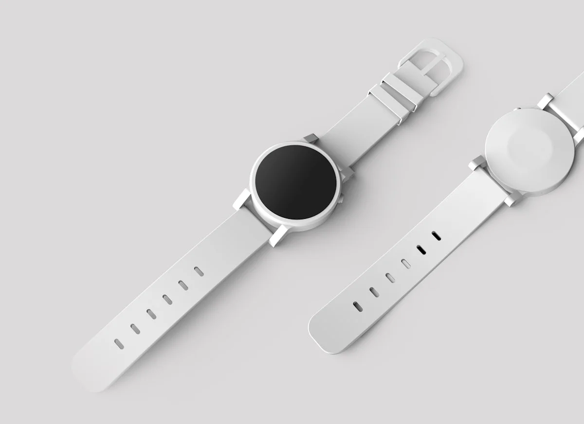 Smart ring på ett finger med hälsodata synlig på en smartphone i bakgrunden.